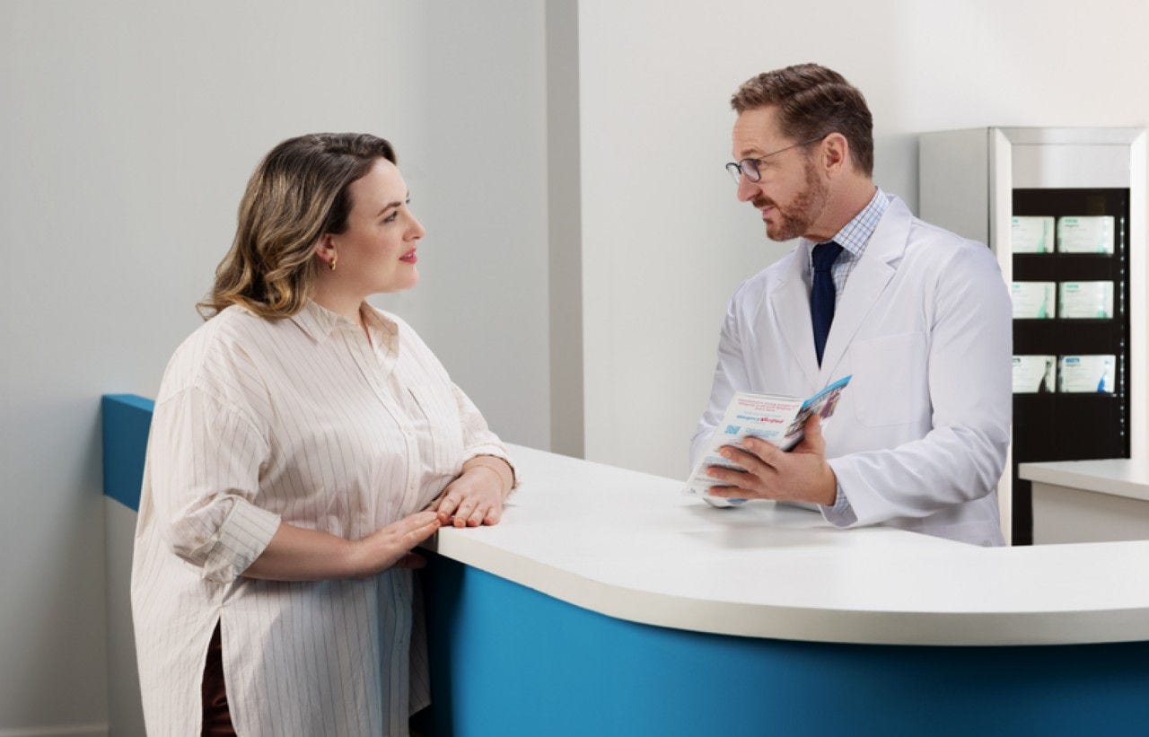 woman speaking to a pharmacist